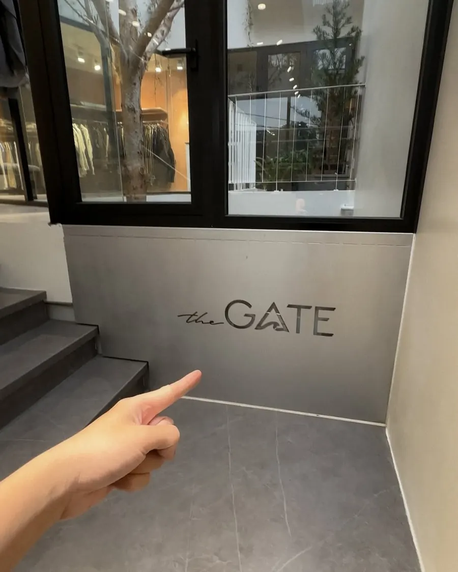Steel "the GATE" sign by the stairs to the mezzanine